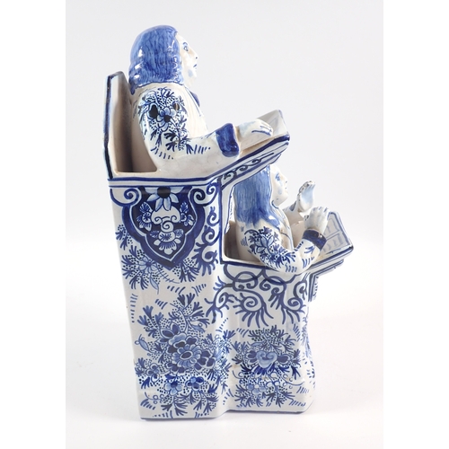 39 - A Delft vicar and Moses group in blue and white, 31cm tall