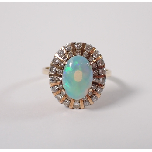 393 - A 14ct gold ring set oval opal within two rows of graduated diamonds, size L, opal 10 x 7mm, 4g