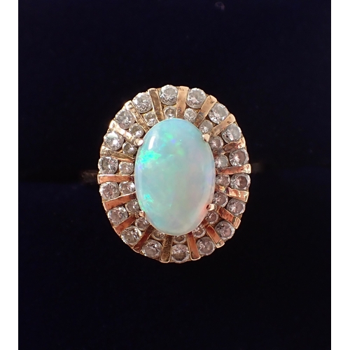 393 - A 14ct gold ring set oval opal within two rows of graduated diamonds, size L, opal 10 x 7mm, 4g
