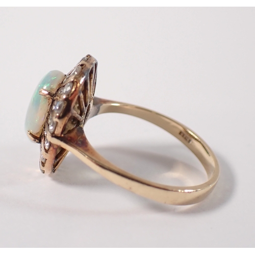 393 - A 14ct gold ring set oval opal within two rows of graduated diamonds, size L, opal 10 x 7mm, 4g