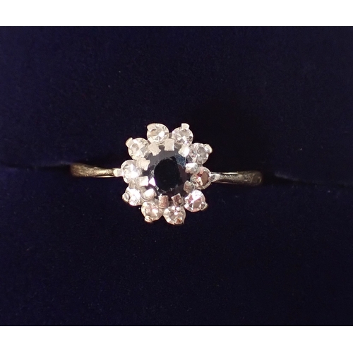 394 - An 18ct gold and platinum sapphire and diamond cluster ring, size M, 2.2g