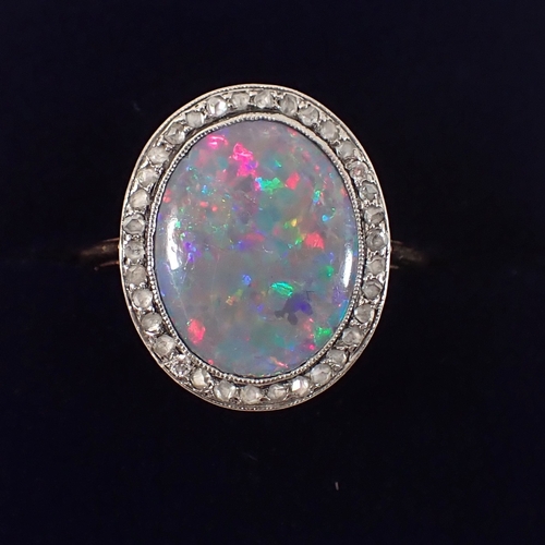 395 - An antique gold ring set black opal within old cut  diamond surround, size M-N, 3g, opal is 14mm x 1... 