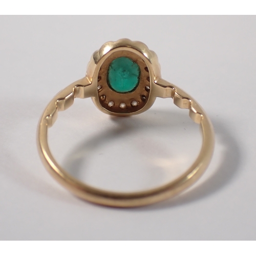 399 - An 18ct gold ring set emerald within diamond surround, size M, 3g