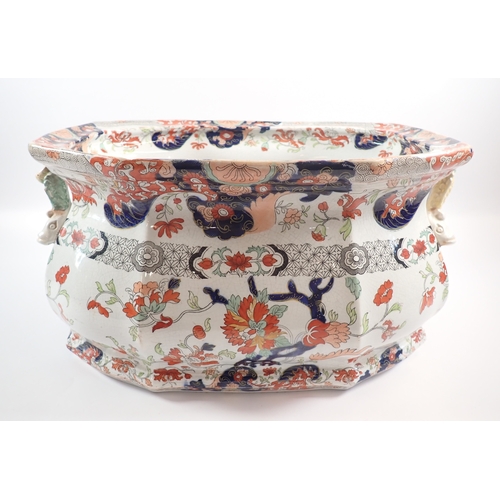 4 - A Victorian Fenton ironstone footbath with dolphin handles and floral printed decoration, 46cm wide