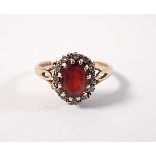 400 - A 9ct gold ring set garnet within diamond surround, size P, 3g