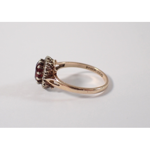 400 - A 9ct gold ring set garnet within diamond surround, size P, 3g