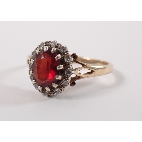 400 - A 9ct gold ring set garnet within diamond surround, size P, 3g