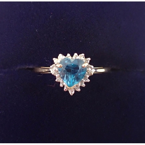 403 - A 9ct gold ring set heart cut blue topaz with chip diamond surround, size L/M, 1.7g
