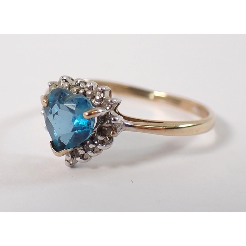 403 - A 9ct gold ring set heart cut blue topaz with chip diamond surround, size L/M, 1.7g