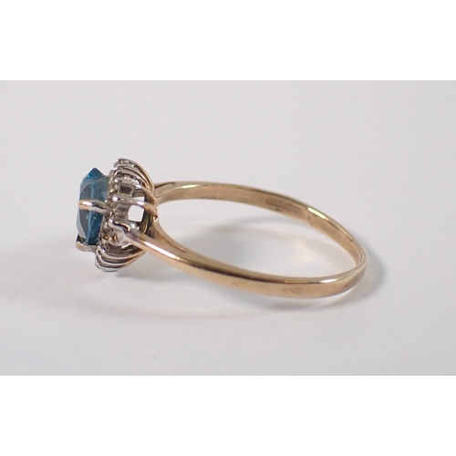 403 - A 9ct gold ring set heart cut blue topaz with chip diamond surround, size L/M, 1.7g