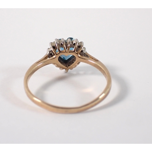 403 - A 9ct gold ring set heart cut blue topaz with chip diamond surround, size L/M, 1.7g