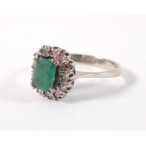 409 - An antique 18 carat white gold ring set emerald within illusion set diamond surround, size M, emeral... 