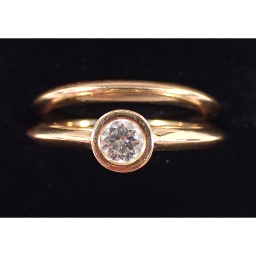 410 - An 18 carat gold matching wedding ring and engagement ring by Martin & Co, the collet set diamond ap... 