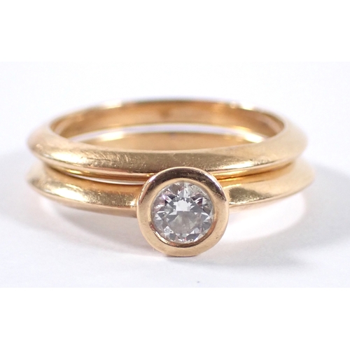 410 - An 18 carat gold matching wedding ring and engagement ring by Martin & Co, the collet set diamond ap... 