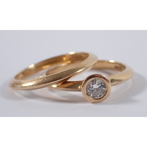 410 - An 18 carat gold matching wedding ring and engagement ring by Martin & Co, the collet set diamond ap... 