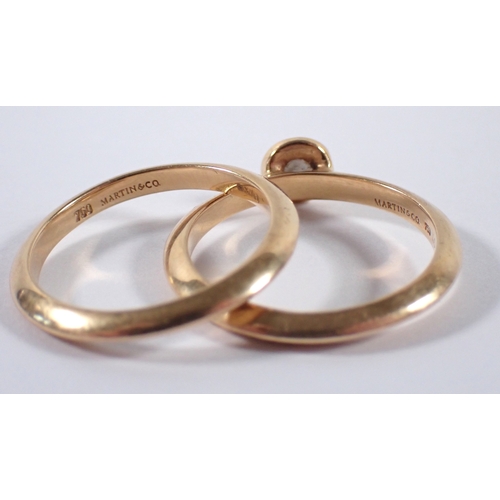 410 - An 18 carat gold matching wedding ring and engagement ring by Martin & Co, the collet set diamond ap... 