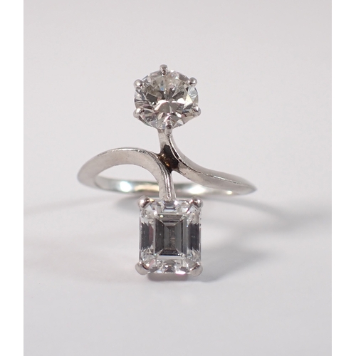 411 - A Toi et Moi platinum and diamond two stone crossover style ring, the round brilliant cut 1ct diamon... 