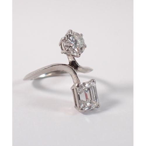 411 - A Toi et Moi platinum and diamond two stone crossover style ring, the round brilliant cut 1ct diamon... 