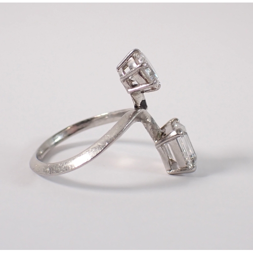 411 - A Toi et Moi platinum and diamond two stone crossover style ring, the round brilliant cut 1ct diamon... 