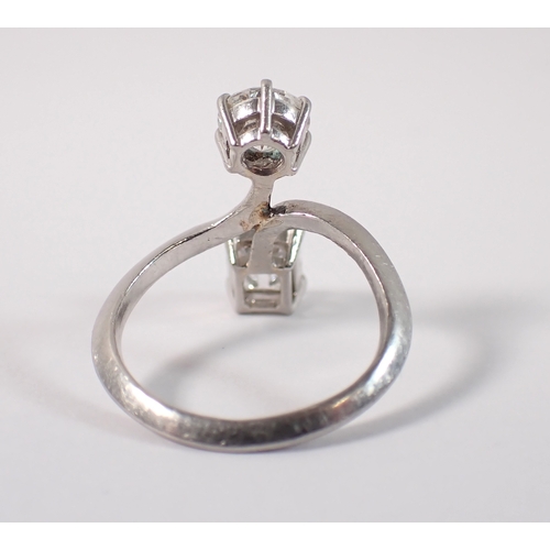 411 - A Toi et Moi platinum and diamond two stone crossover style ring, the round brilliant cut 1ct diamon... 