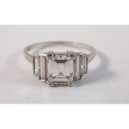 412 - An Art Deco platinum and diamond ring with emerald cut diamond 1.52cts, flanked either side by two g... 