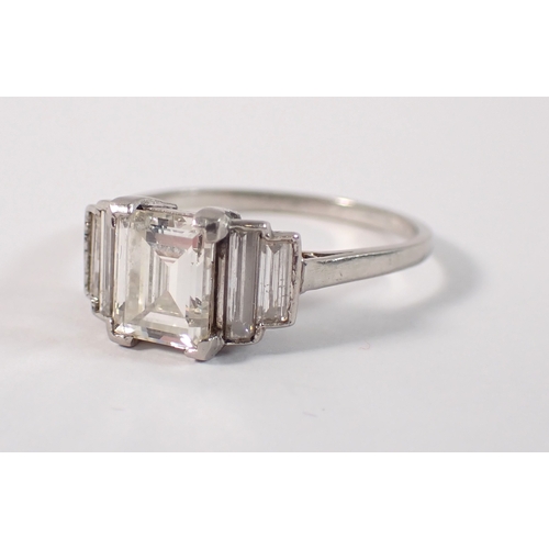 412 - An Art Deco platinum and diamond ring with emerald cut diamond 1.52cts, flanked either side by two g... 