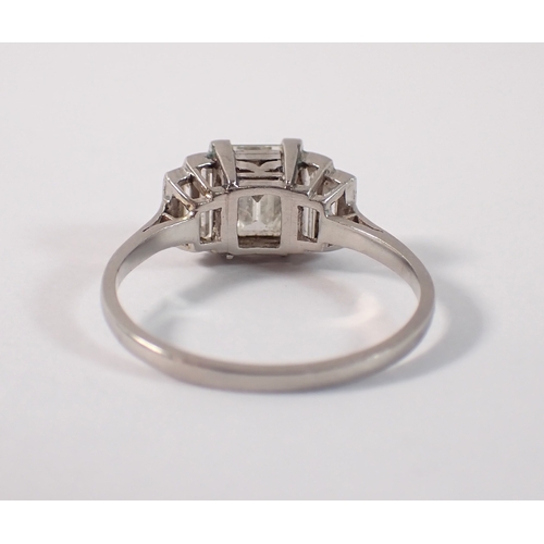 412 - An Art Deco platinum and diamond ring with emerald cut diamond 1.52cts, flanked either side by two g... 