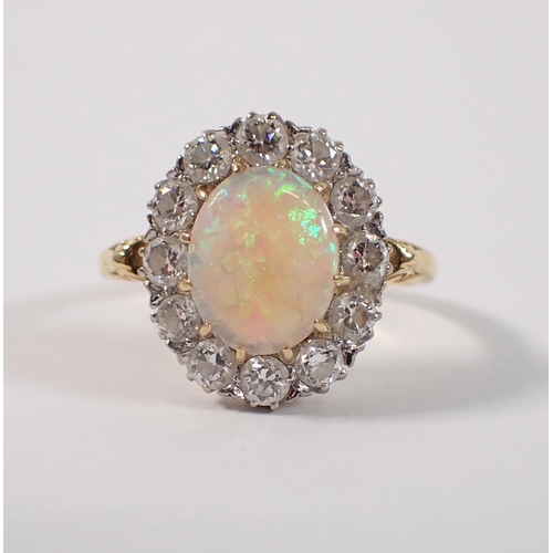 413 - An 18ct gold oval cut opal ring with diamond surround, size P, opal 10 x 8mm, diamonds 3mm, 4.2g, ma... 