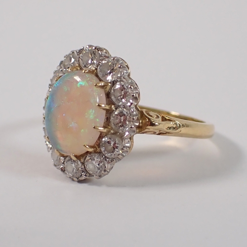 413 - An 18ct gold oval cut opal ring with diamond surround, size P, opal 10 x 8mm, diamonds 3mm, 4.2g, ma... 