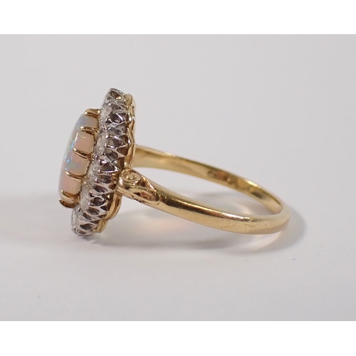 413 - An 18ct gold oval cut opal ring with diamond surround, size P, opal 10 x 8mm, diamonds 3mm, 4.2g, ma... 