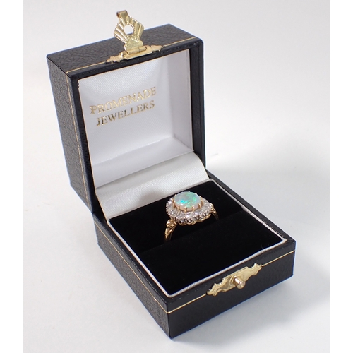 413 - An 18ct gold oval cut opal ring with diamond surround, size P, opal 10 x 8mm, diamonds 3mm, 4.2g, ma... 