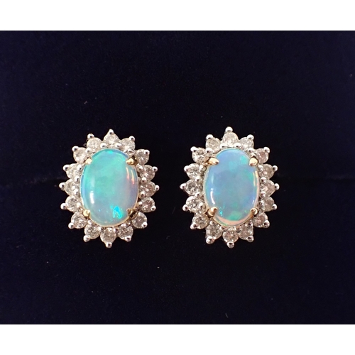 415 - A pair of 14ct gold opal and diamond cluster earrings, opals 7 x 5mm, 3.2g