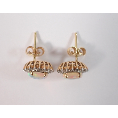 415 - A pair of 14ct gold opal and diamond cluster earrings, opals 7 x 5mm, 3.2g