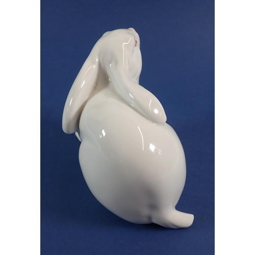 55 - A Herend white rabbit with raised paw, 10cm tall