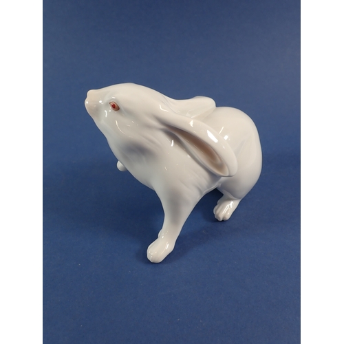 55 - A Herend white rabbit with raised paw, 10cm tall