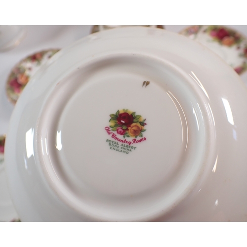 9 - A Royal Albert Country Roses teapot, sugar, jug, seven saucers, five tea plates, an ashtray and a ca... 