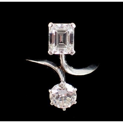 411 - A Toi et Moi platinum and diamond two stone crossover style ring, the round brilliant cut 1ct diamon... 