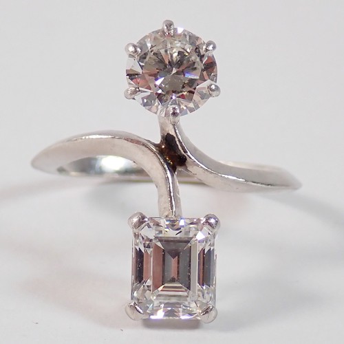 411 - A Toi et Moi platinum and diamond two stone crossover style ring, the round brilliant cut 1ct diamon... 
