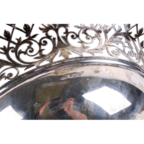 1 - An early 20th century silver pedestal bowl. The rim and foot with a pierced border of scrolls and le... 