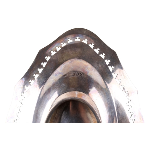 22 - A late Victorian silver oval bonbon dish. With a fluted rim, pierced leaf border over engraved swags... 