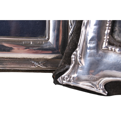 49 - Three silver photograph frames. Two of matching pattern with crosses reeded outer border, the third ... 