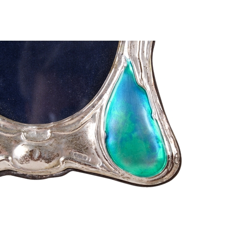 50 - An Art Nouveau style silver mirror. Of organic flowing form, four raised sections with transparent t... 