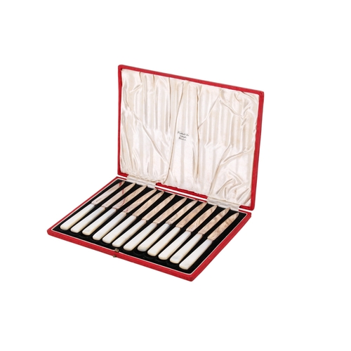 14 - A boxed set of twelve silver and mother of pearl fruit knives. Hallmarks for James Dixon & Sons Ltd,... 