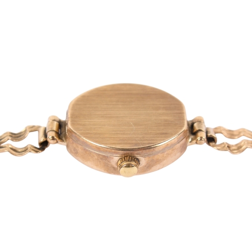 199 - A 9ct gold lady's Geneve Gold quartz dress watch. Gilt markers to the champagne face, hallmarks to s... 