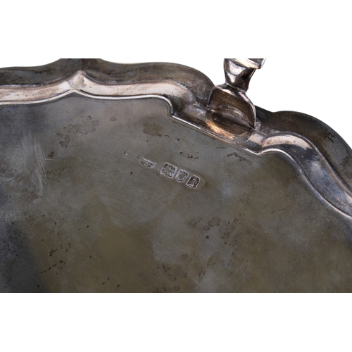 2 - An Edwardian silver salver. Having a shaped moulded rim, on three pad feet, hallmarked Hawksworth, E... 