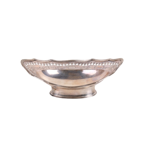 22 - A late Victorian silver oval bonbon dish. With a fluted rim, pierced leaf border over engraved swags... 