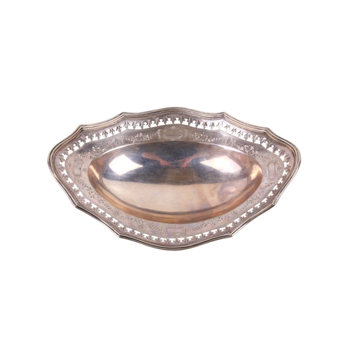 22 - A late Victorian silver oval bonbon dish. With a fluted rim, pierced leaf border over engraved swags... 