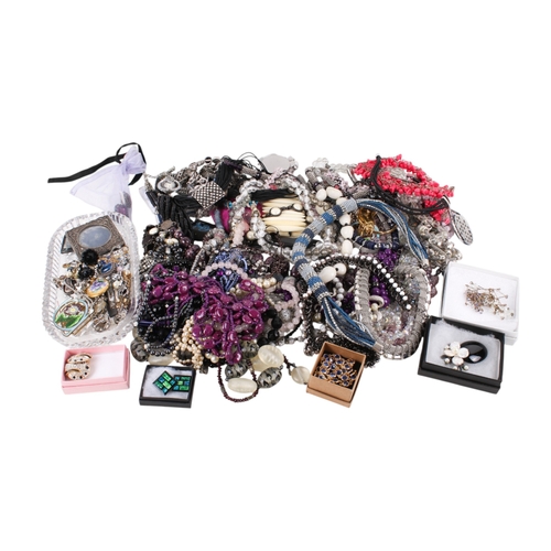 228 - A collection of costume jewellery. Including many beaded necklaces, brooches, a small silver photogr... 