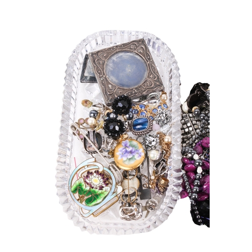 228 - A collection of costume jewellery. Including many beaded necklaces, brooches, a small silver photogr... 