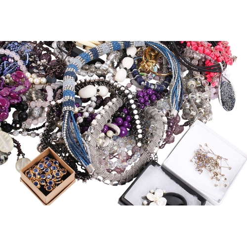 228 - A collection of costume jewellery. Including many beaded necklaces, brooches, a small silver photogr... 